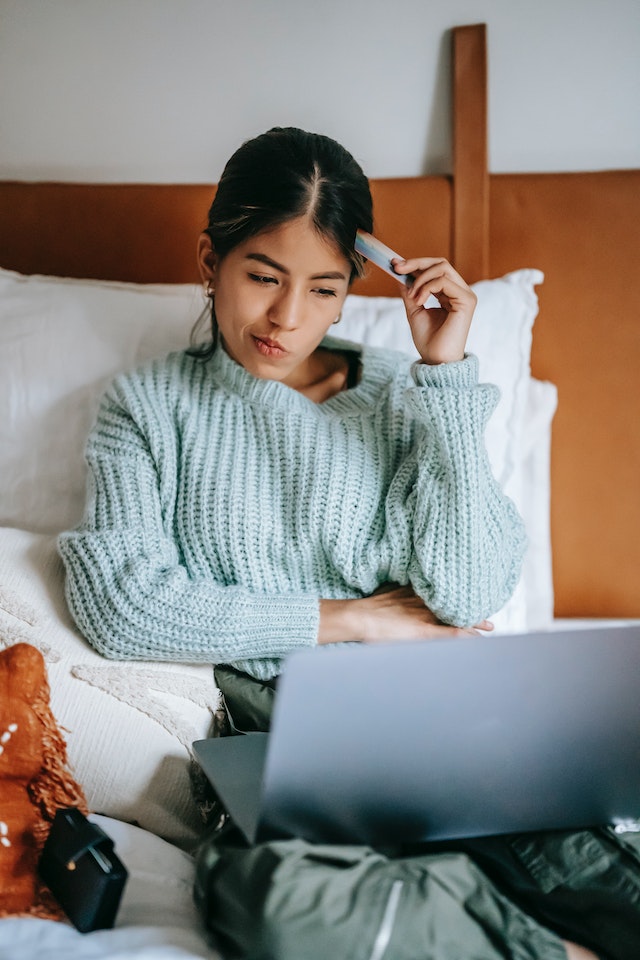 woman considering spending money woman considering spending money